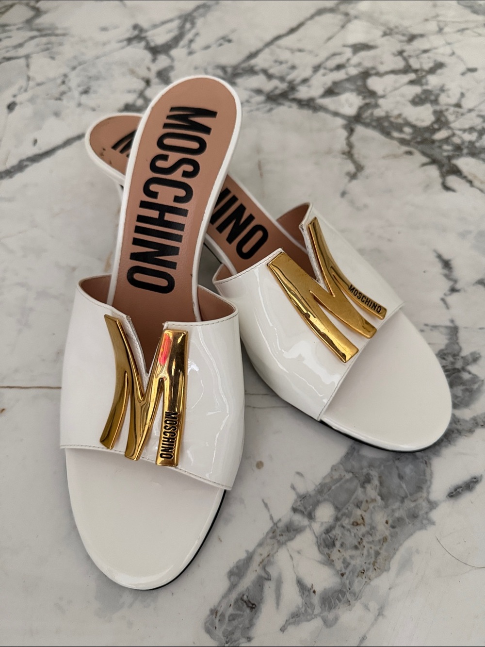 Moschino White Patent Slide Mules with Gold Plaque